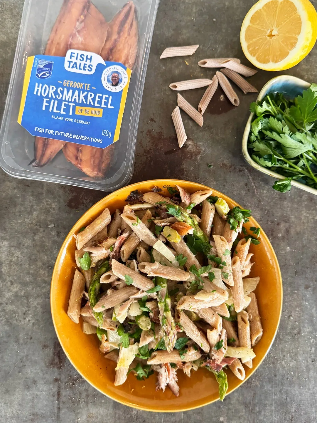 Pasta salad with smoked mackerel, arugula, and lemon, alongside ingredients.